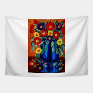 A lovely boutique of abstract bright abd vibrant l flowers in a tall glass  blue vase . Tapestry