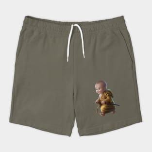 Baby with a Pixelated area Over the Face, Dressed in Traditional Monk Attire with a staff in Hand Shorts