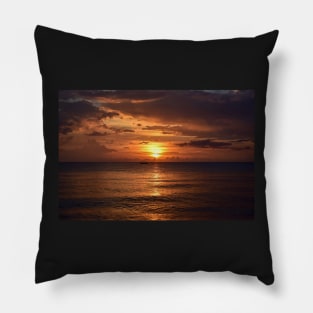 Mesmerizing vertical shot of the sun setting behind the clouds over the calm ocean Pillow