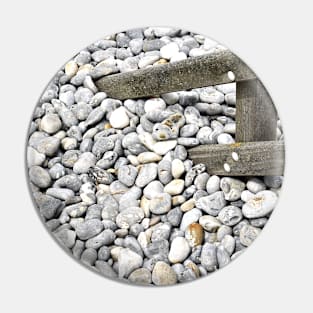 Pebbles covering a fence at  Sheringham, UK Pin