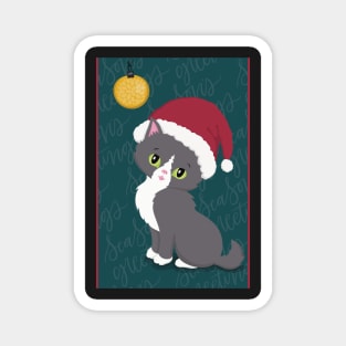 Cute Christmas card with a little kitten in a Christmas hat looking at a bauble. Magnet