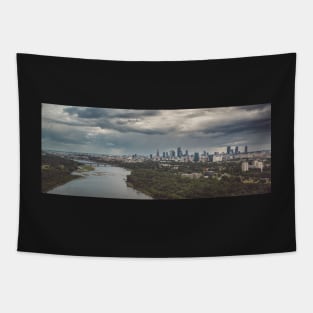 Moody sky over distant city Tapestry