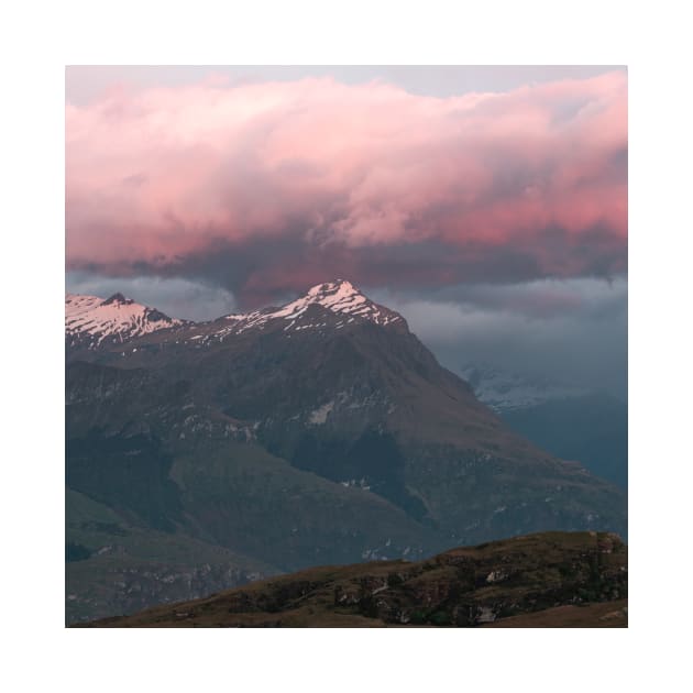 Mountain Peak With Pink Cloud Above During Sunrise by Danny Wanders