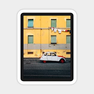 Vintage Car Parked in Front of Yellow Apartment Building in Italy Magnet