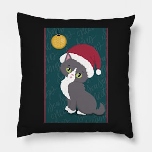 Cute Christmas card with a little kitten in a Christmas hat looking at a bauble. Pillow