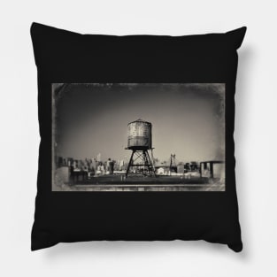 Sepia-toned image of a rusty water tower on a rooftop of Queens, in New York City, with the Queensboro Bridge and the Manhattan skyline in the background. Pillow