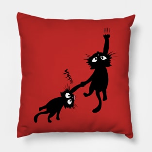 Black cat holding on Pillow