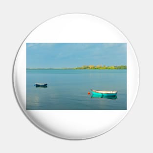 Catching the late sun - Two dinghies floating idly on calm harbour water at Tauranga New Zealand Pin