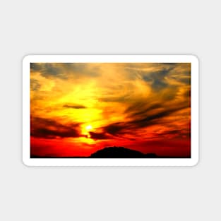 Apocalyptic scenery with a bath of violent clouds in the sunset sky full of raging red and yellow colours Magnet