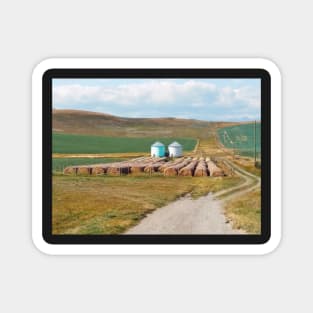 Grain silo with crop wheat rolls in Alberta. Canadian prairie landscape in autumn season. Magnet