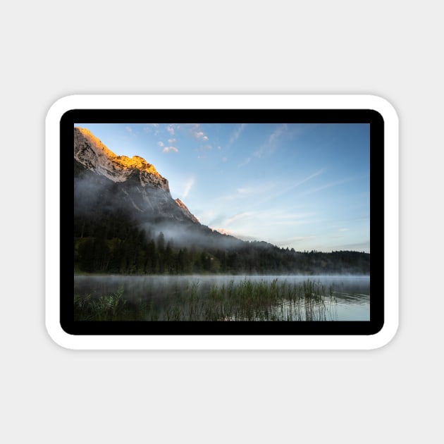 Mist on Alp mountain at Ferchensee. Amazing shot of the Ferchensee lake in Bavaria, Germany, in front of a mountain. Scenic foggy morning scenery at sunrise. Magnet by EviRadauscher