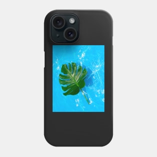 Monstera deliciosa plant floating on blue water Phone Case