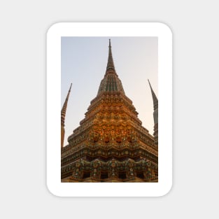 Low angle view of a Buddha stupa reaching symmetrical in the clear sky. Magnet