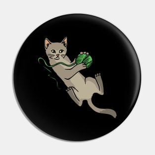 A cute cat playing with a green woolball Pin