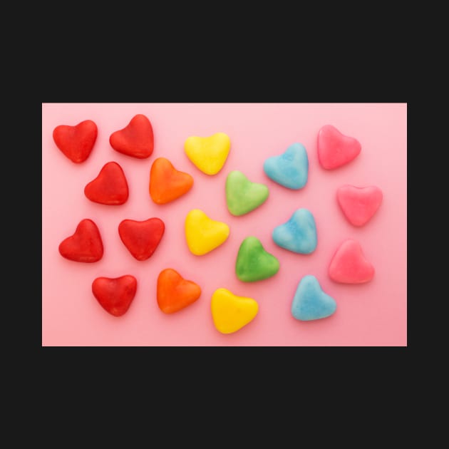 Heart-shaped colorful candy arranged in rainbow colors, on a pink background by karinelizabeth