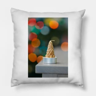 Christmas tree shaped candle on wooden cupboard against christmas lights Pillow