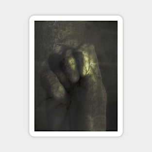 Digital collage and special processing. Clenched palm. Calm and soft. Like some fog, medieval. Like gold or bronze. Magnet