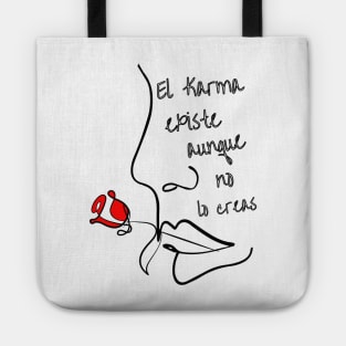 Phrase in Spanish: Karma exists N.2. Abstract and linear face of a woman in black biting a red rose. Tote