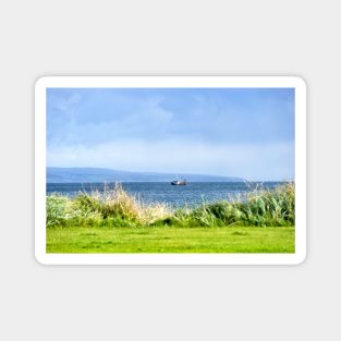 Fishing boat moving along the coast at Peninver, Scotland Magnet