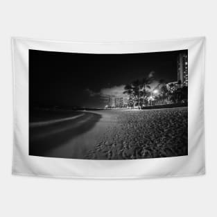 Beach palm trees and  buildings of Waikiki from beach on tropical island  night Tapestry