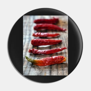 Dried chili peppers on a wooden board Pin