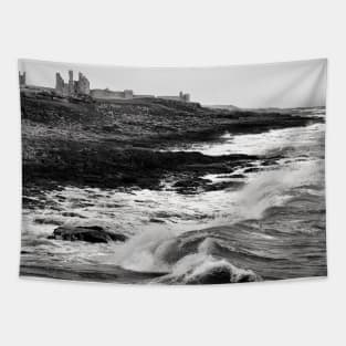Rough waves hit the rocks near Dunstanburgh castle in Northumberland, UK Tapestry