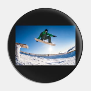 Snowboarder jumping against blue sky Pin