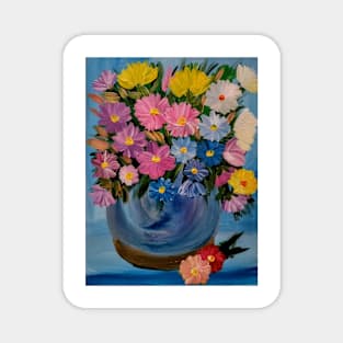 A lovely boutique of flowers in a blue vase . Magnet