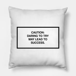 Caution: Daring to try may lead to success. Pillow