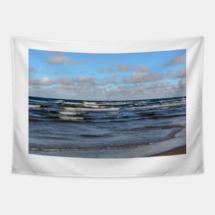 White cumulus clouds in sky over wavy Baltic sea Tapestry