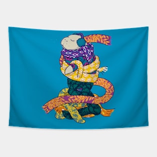 Winter manatee wrapped in scarves on snowy background Tapestry