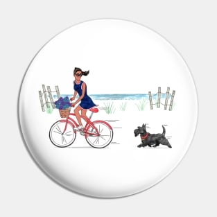 Girl on bike with Scottie dog riding on beach. Pin