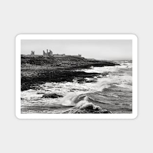 Rough waves hit the rocks near Dunstanburgh castle in Northumberland, UK Magnet