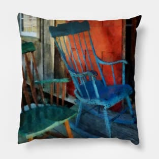 Blue and Green Rocking Chairs Against Red Door Pillow