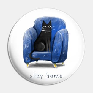 Cartoon black cat in a blue armchair and the inscription "Stay home". Pin
