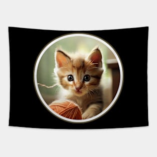 A playful kitten chasing a ball of yarn. Tapestry