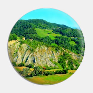 Scenery from Castignano with a hill of ravines and green colours, a valley and the Sibillini Pin