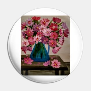 Abstract red and pink flowers im a metallic blue jug vase . On a table Pin