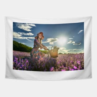 Young woman riding her bicycle in a lavender field Tapestry