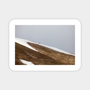 Three tourists walking at the mountains Magnet