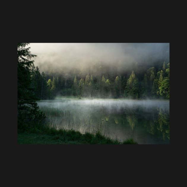 Magic Misty Lake. Amazing shot of a wooden house in the Ferchensee lake in Bavaria, Germany, in front of a mountain belonging to the Alps. Scenic foggy morning scenery at sunrise. by EviRadauscher