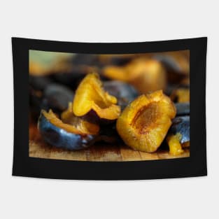 Plums sliced on a wooden board Tapestry