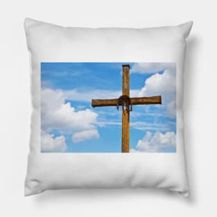 Figurine of Jesus Christ on a wooden cross against under blue cloudy sky Pillow