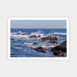 Crashing waves splash into the rocky coastline of California Magnet