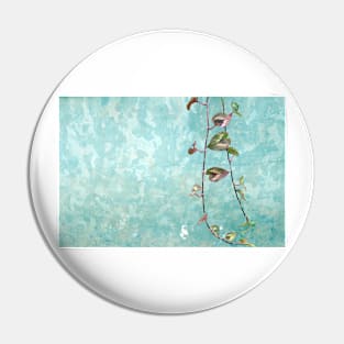 Foliage around a teal background Pin