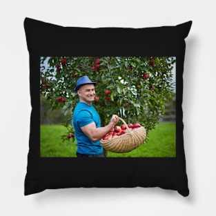 Farmer picking apples in a basket Pillow