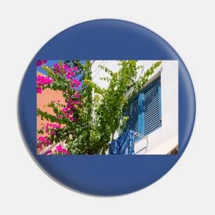 Pink bougainvillea climber and blue shutters in Greece. Pin