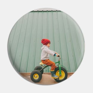 a child on a bicycle Pin