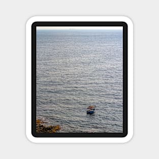 Lonely boat floating on the Mediterranean sea Magnet