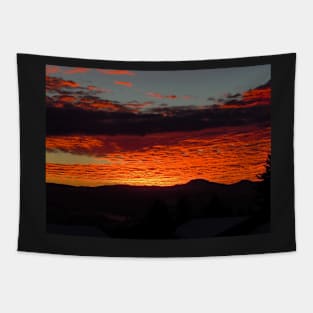 Burnt orange sunset reflecting off the clouds Tapestry